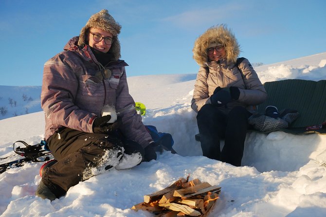 Snowshoeing With A View - Basecamp warmth: the grill cabin meal near the fire